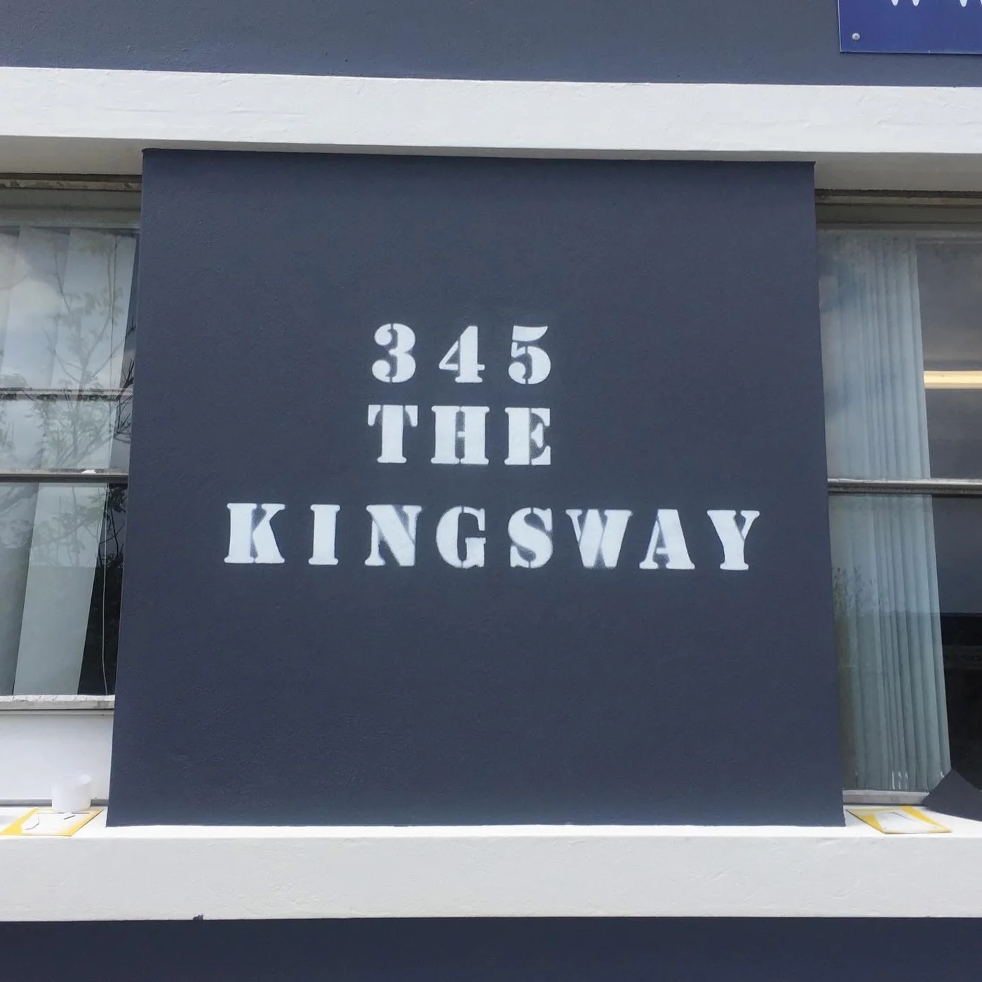 White lettering and trim on a painted charcoal shopfront