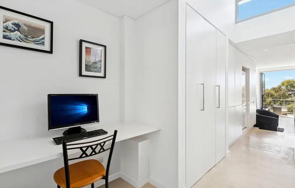 Repainted study nook with white built-in wardrobe doors and frames