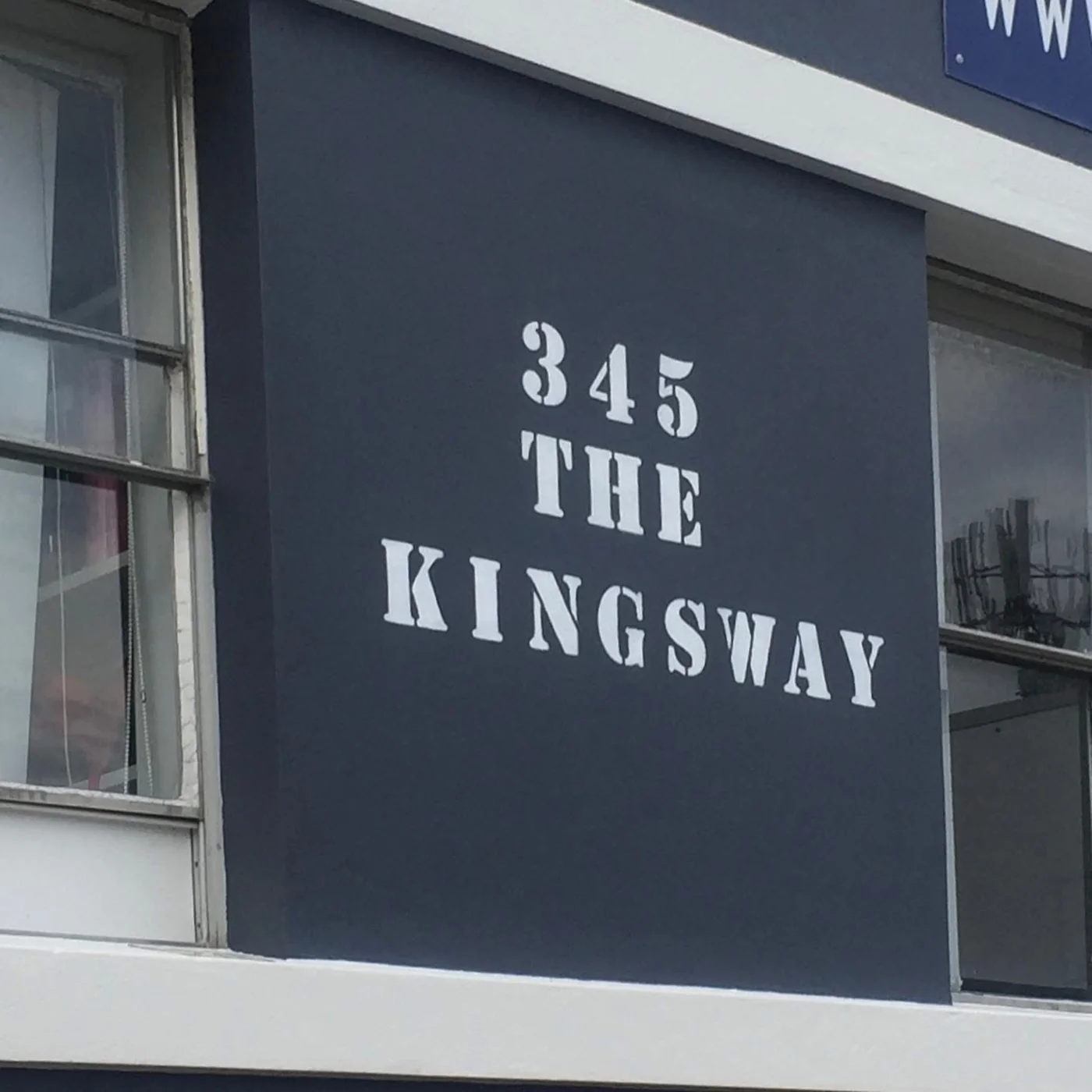 Fresh charcoal painted wall with white street-number lettering